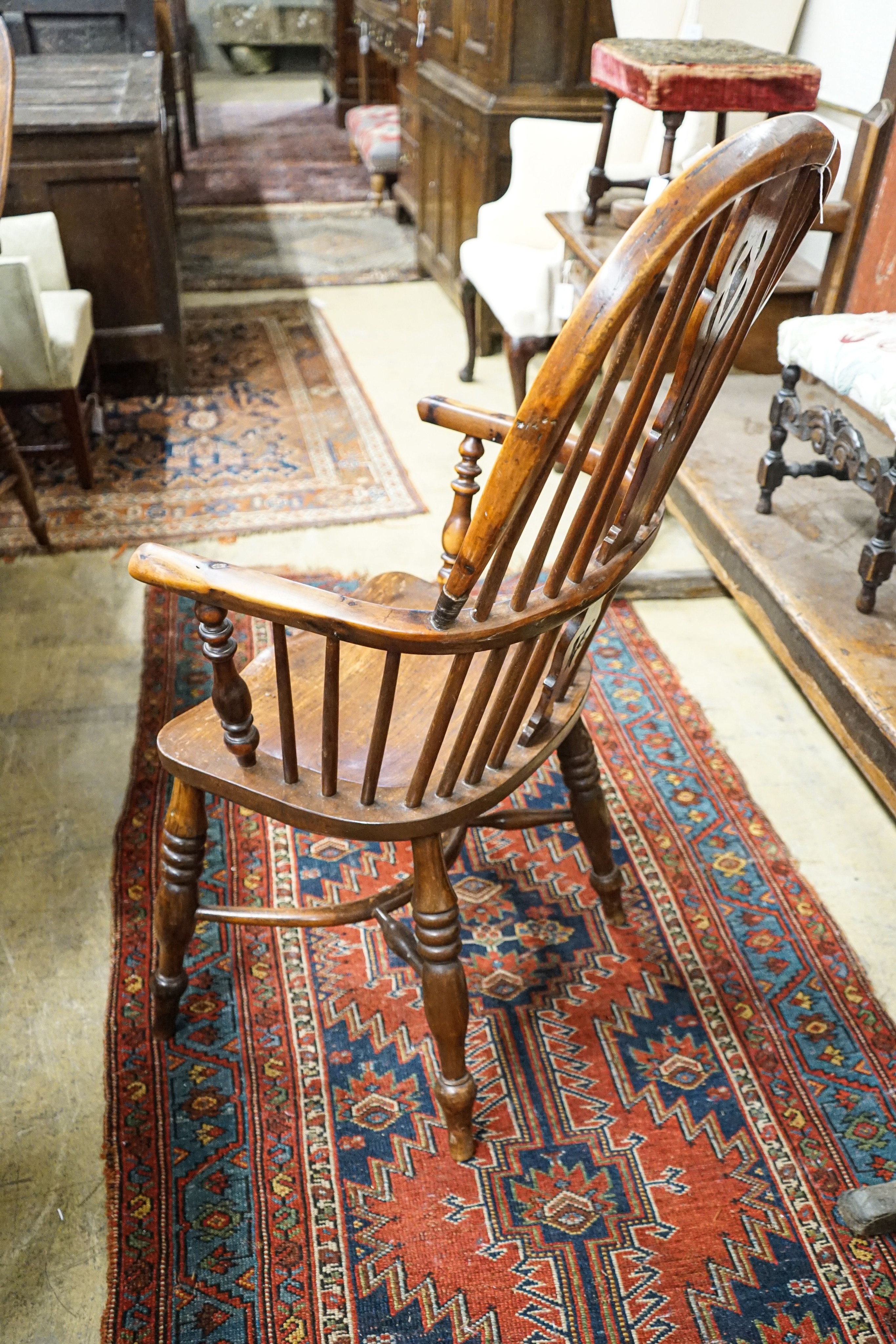 A harlequin set of four Victorian Windsor chairs, comprising near pair of yew, beech and elm, with crinoline stretchers and two others in oak, elm and ash with H stretchers